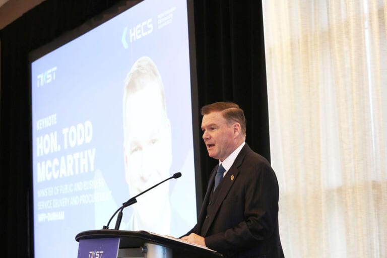Conference speaker presenting to an audience in Toronto