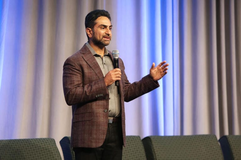 Keynote speaker addressing delegates from the main stage at a Toronto conference